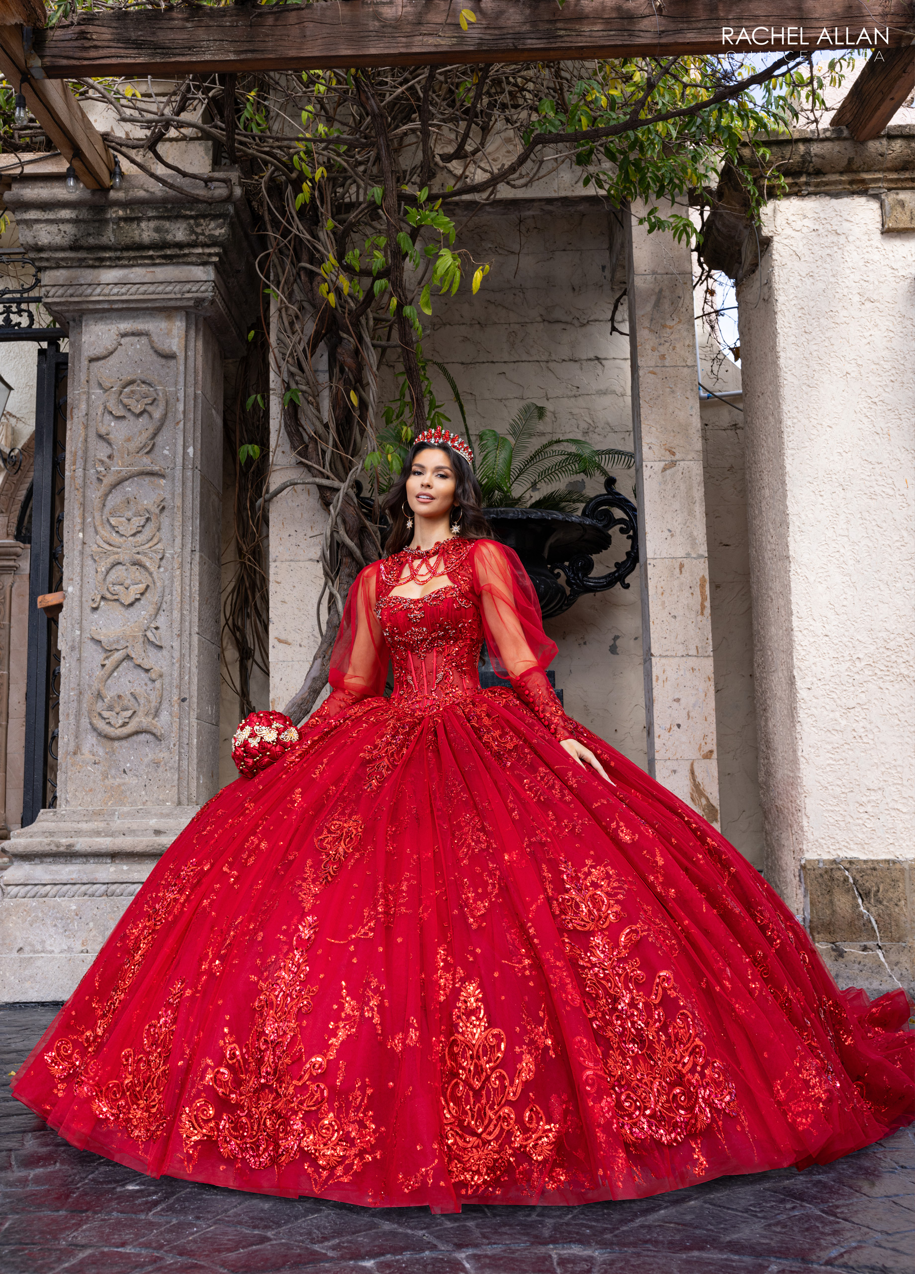 Rachel Allan deep red quinceañera dress with intricate golden embroidery and long sleeves from Carmina Collection
