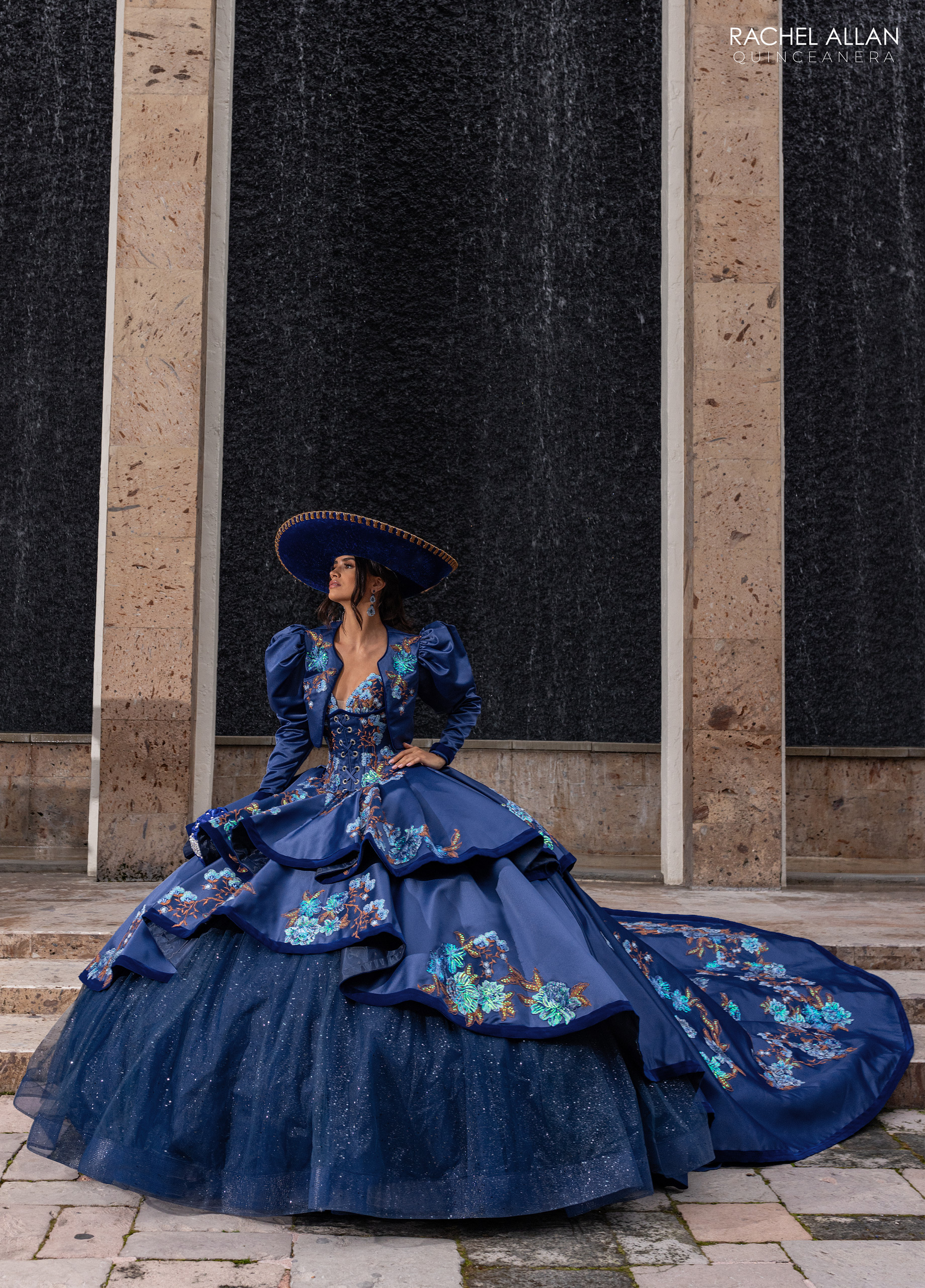 Rachel Allan navy multi quinceañera dress with colorful floral patterns and off-shoulder design from Charro Collection