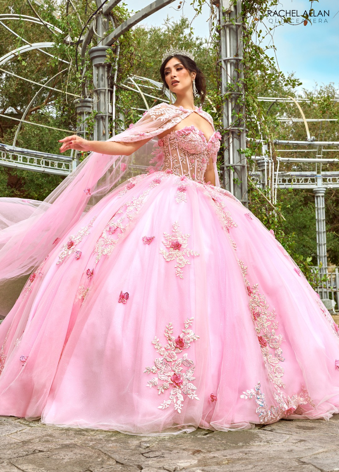 Pink ballgown quinceañera dress with butterfly appliqués and glitter cape