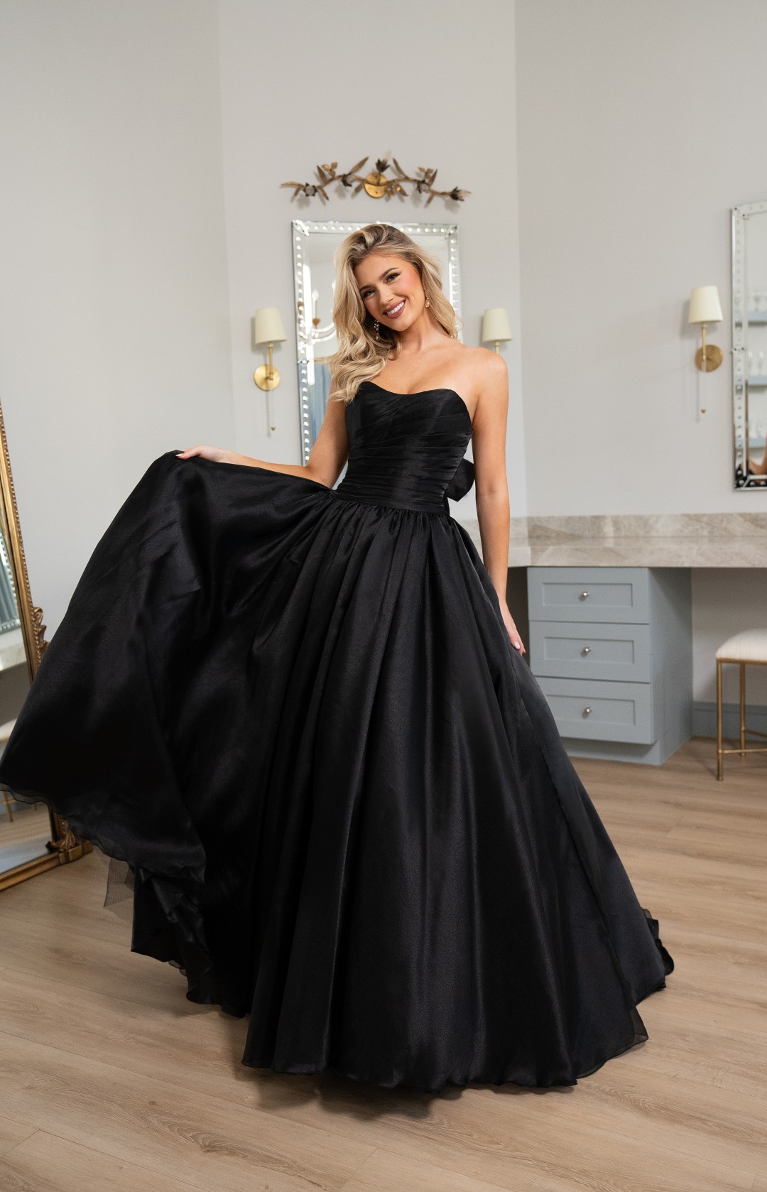 Black fitted prom dress with dramatic cutouts, ruched bodice, and sweeping train