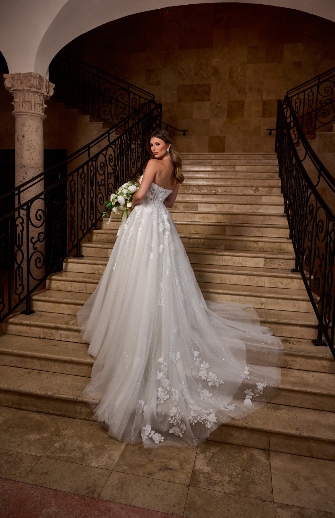 Strapless ivory mermaid bridal gown with tulle overskirt and intricate beading