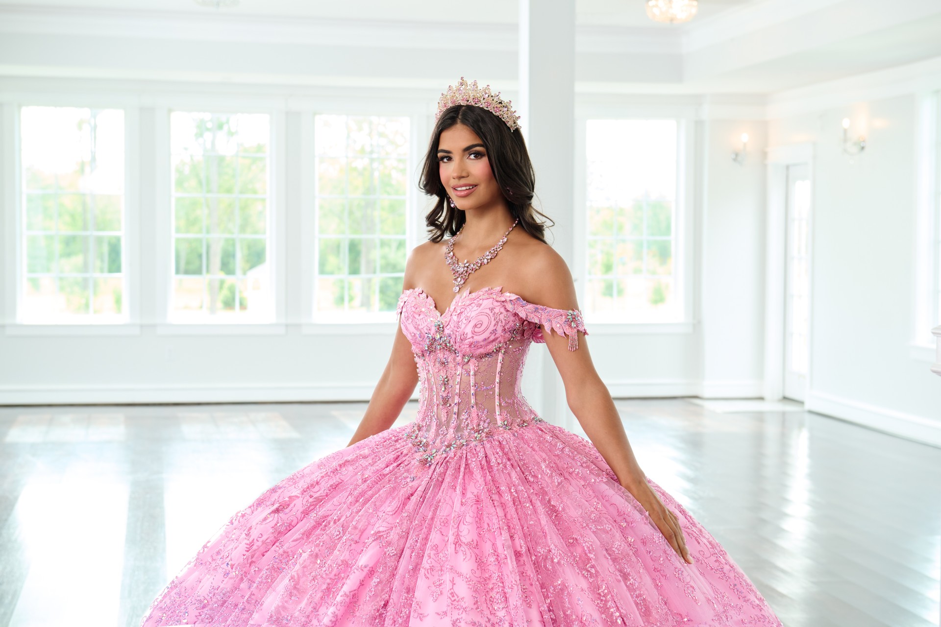 Pink floral applique quinceañera ballgown with off-the-shoulder sleeves and sparkling tulle skirt