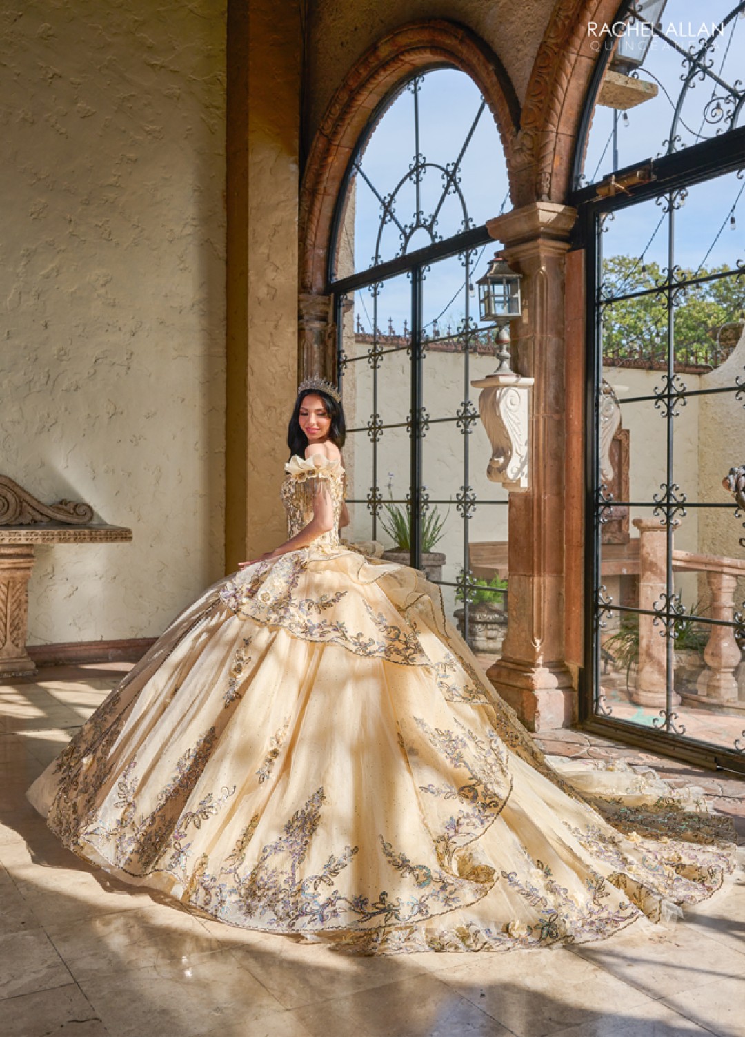 Champagne quinceañera dress with beaded bodice and pleated tulle skirt