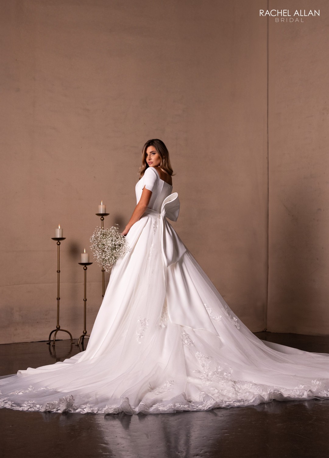 Modest bridal gown with long lace sleeves, high neckline, and full A-line skirt