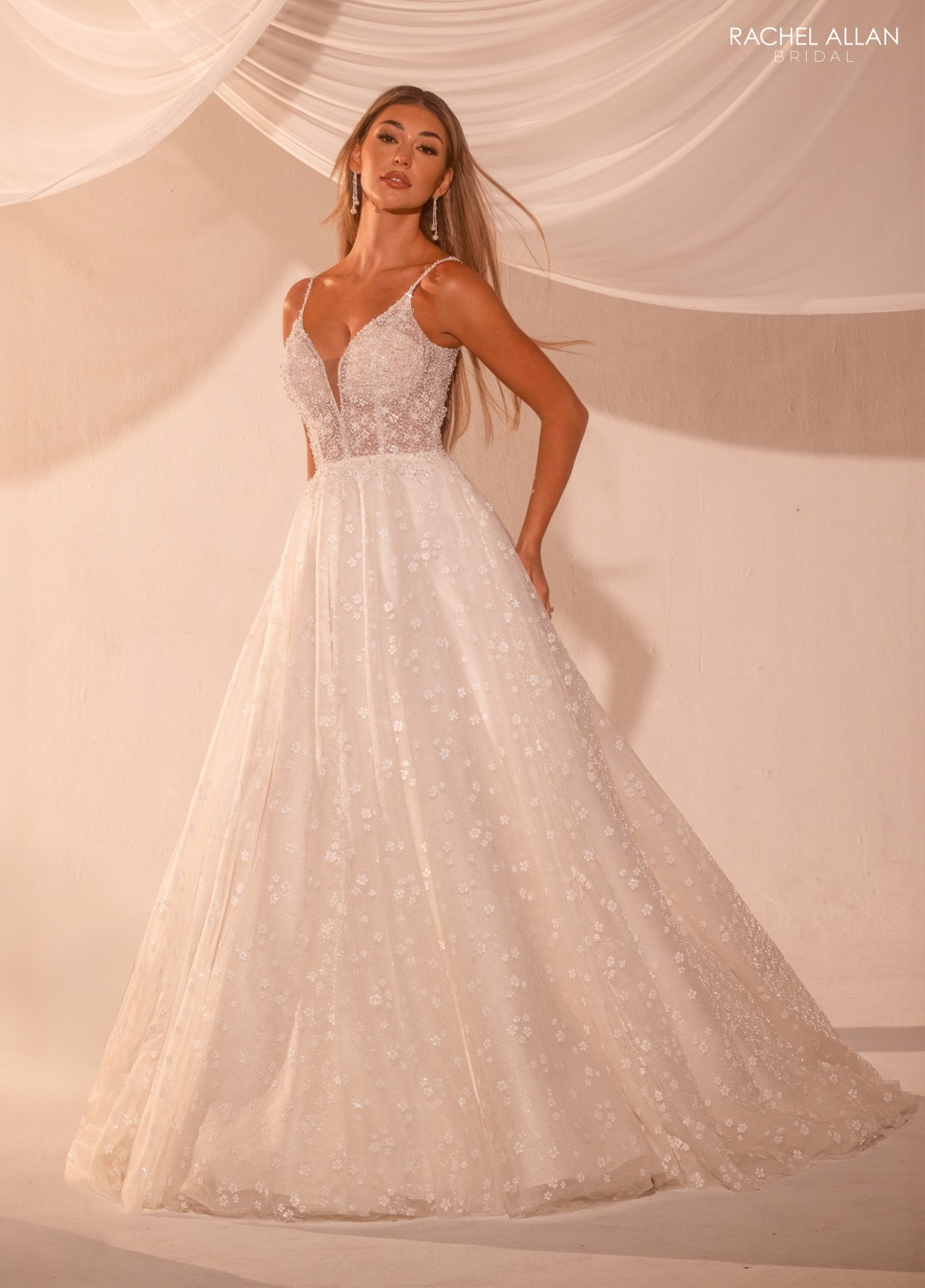 Lace mermaid bridal gown with detachable tulle cape and floral appliqué