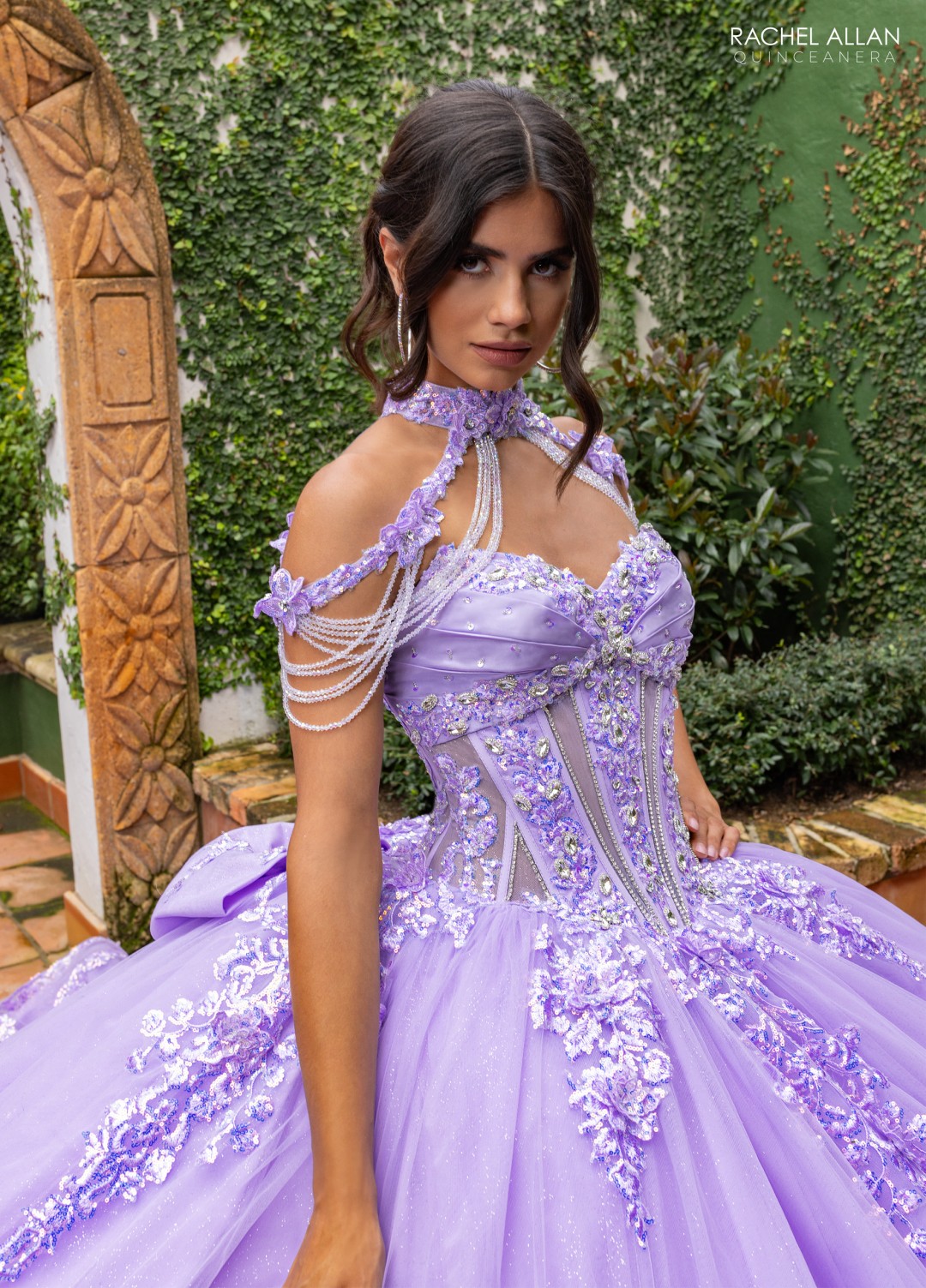 Purple La Reina Quinceañera gown with glitter overlay and dramatic sleeves