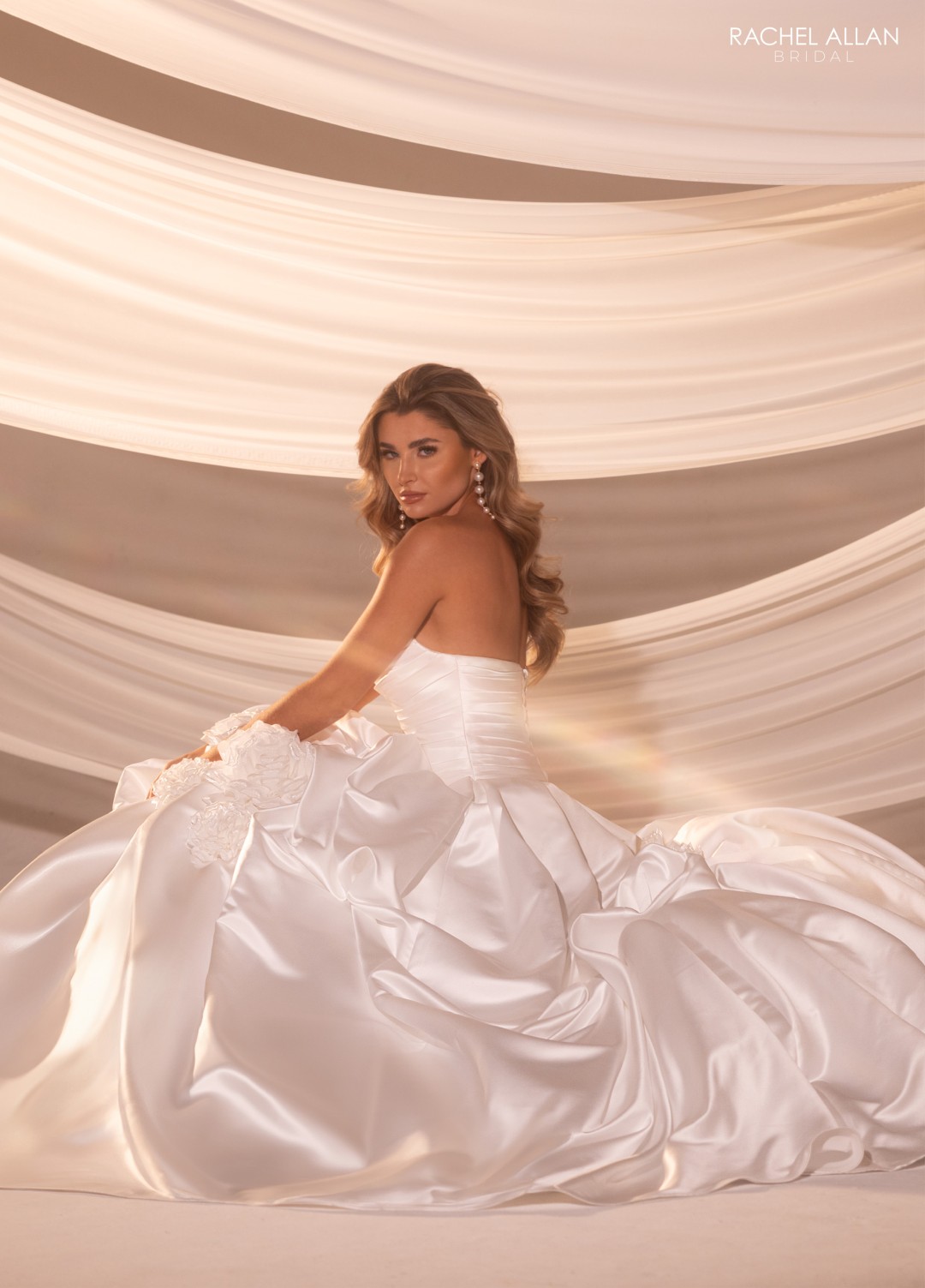 •	Lo' Adoro Style RB5100 ball gown wedding dress featuring plunging neckline with satin and organza construction and 3D flower accents